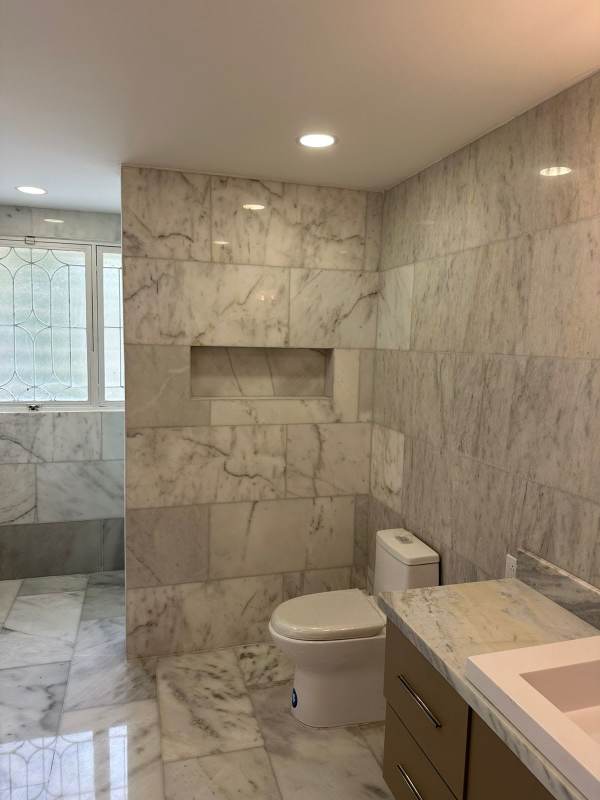 Spacious backyard with pool, gazebos, lush tropical landscaping in Altos del Golf residence Panama