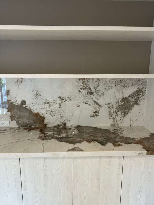 High-end bathroom with marble tiles, built-in niche, modern vanity in luxury Altos del Golf residence