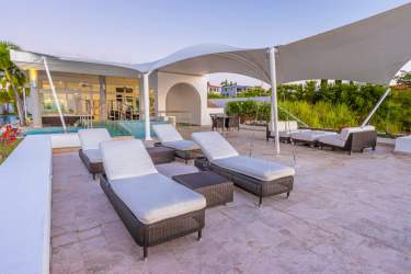 Infinity edge pool with lounge space and ocean horizon at Vista Mar luxury home