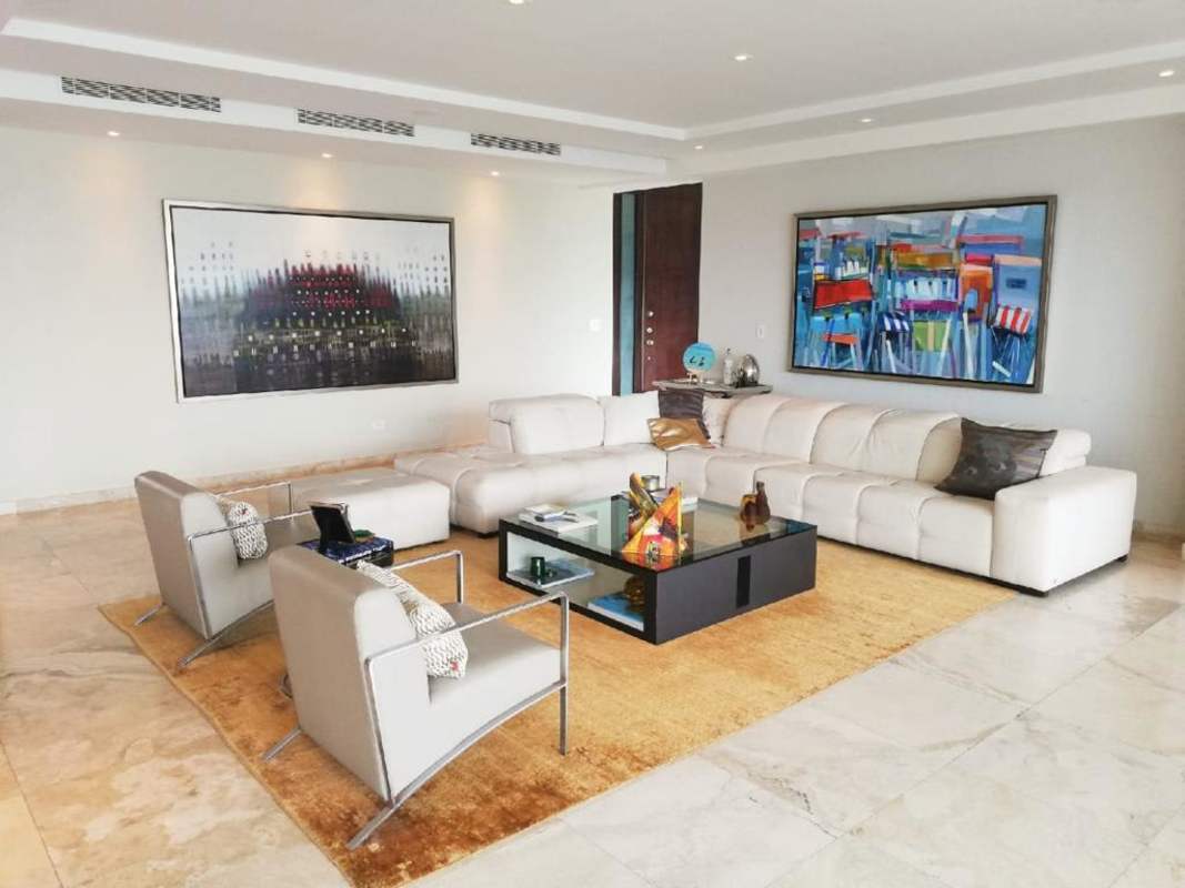 Large open-plan living room with marble floors, sectional sofa, and city views at PH Aqualina Punta Pacifica