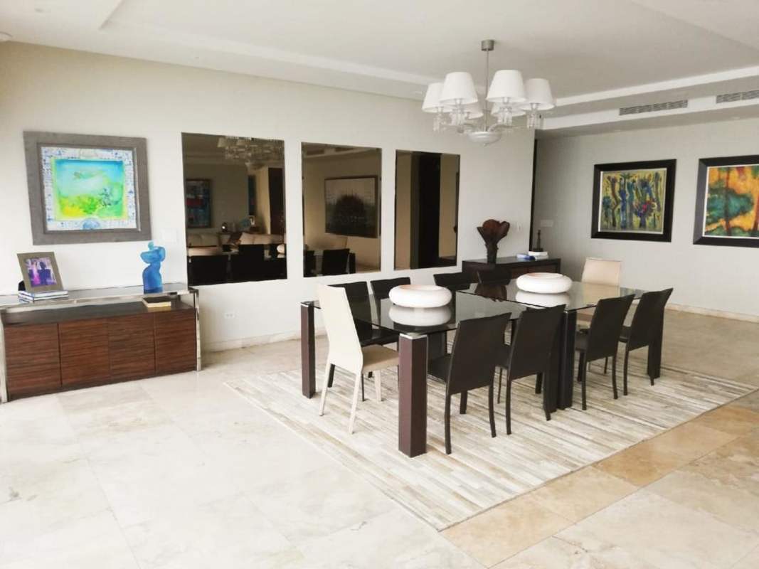 Spacious dining room with artwork, mirror accents, modern chandelier PH Aqualina Punta Pacifica