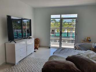 Bright bedroom with flat screen TV and large window Nueva Gorgona luxury estate Panama