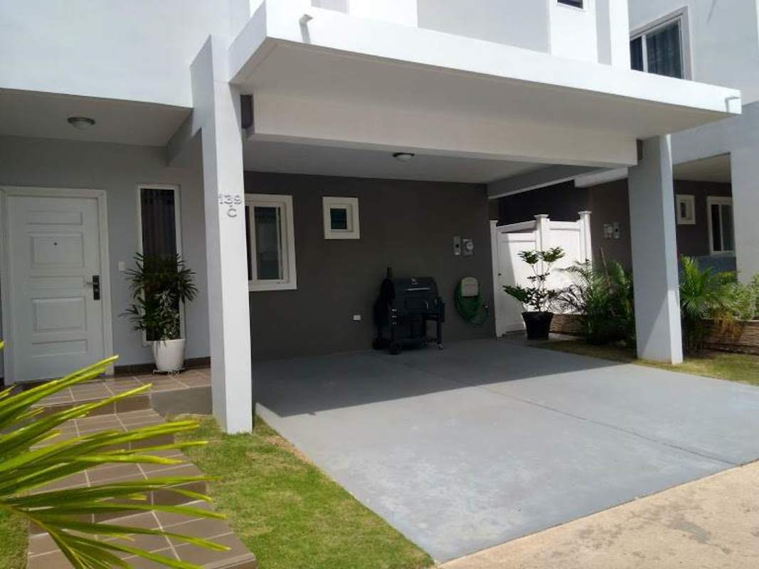 Fully equipped kitchen with dark wood cabinets, stainless appliances and white counters in PH Augusta Panama