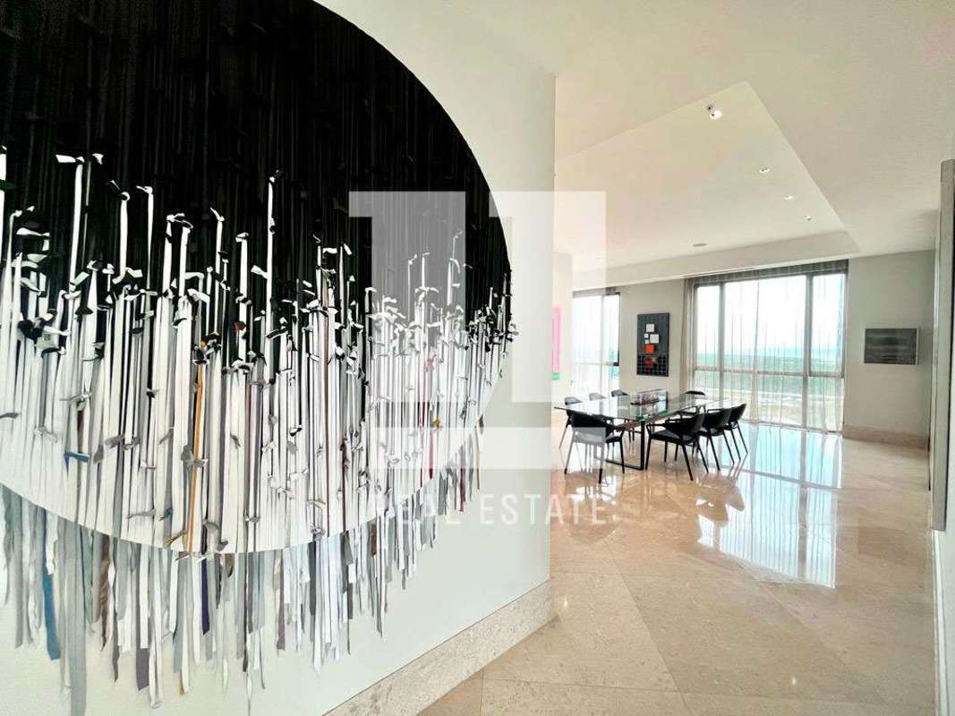 Open plan luxury living and dining room with marble flooring and skyline views in Panama