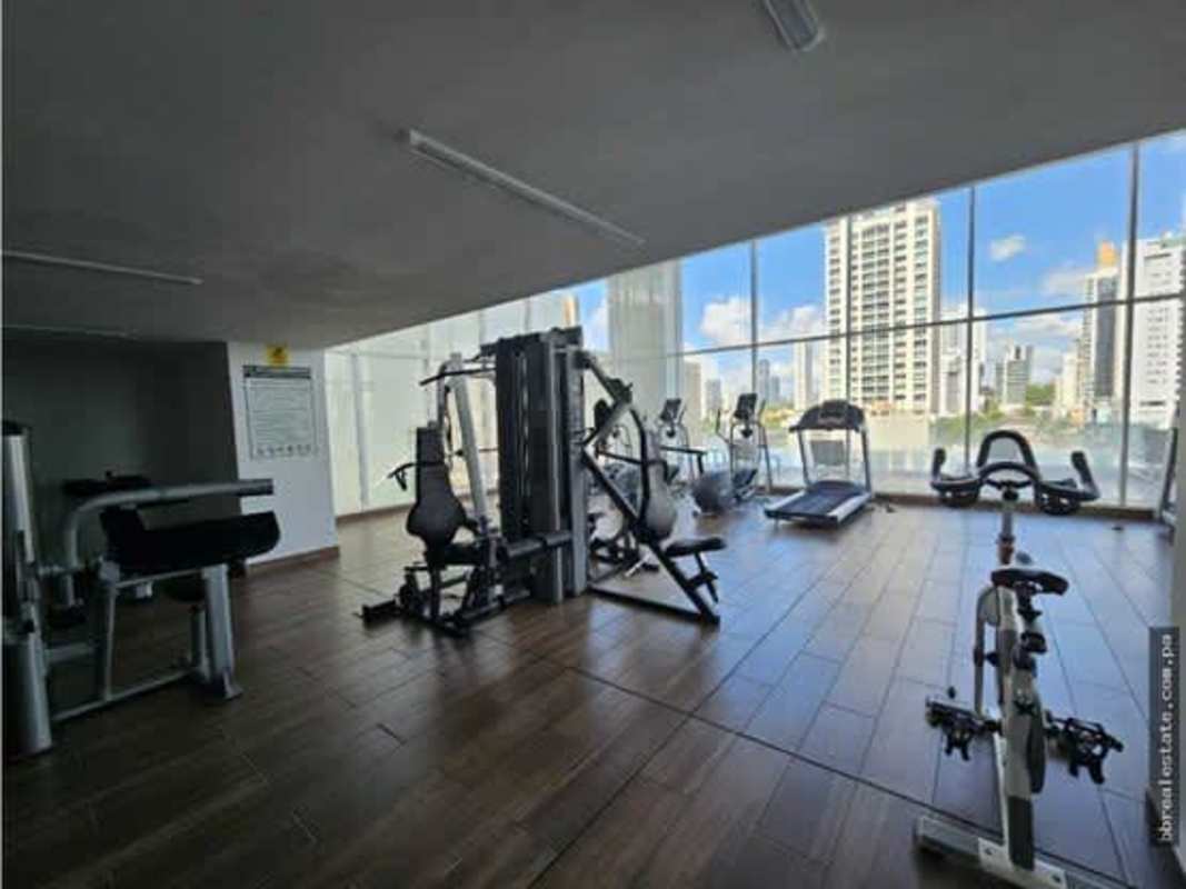 Fully equipped modern gym with city skyline views at PH The Towers in Panama City