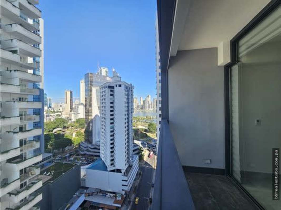 Elegant modern kitchen with white cabinetry, black countertops, appliances in Nuovo by Armani Panama City