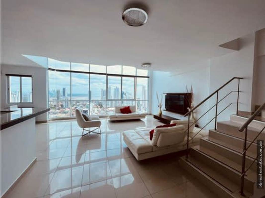 Luxury bedroom with large windows overlooking Panama skyline in PH Premium Tower penthouse San Francisco