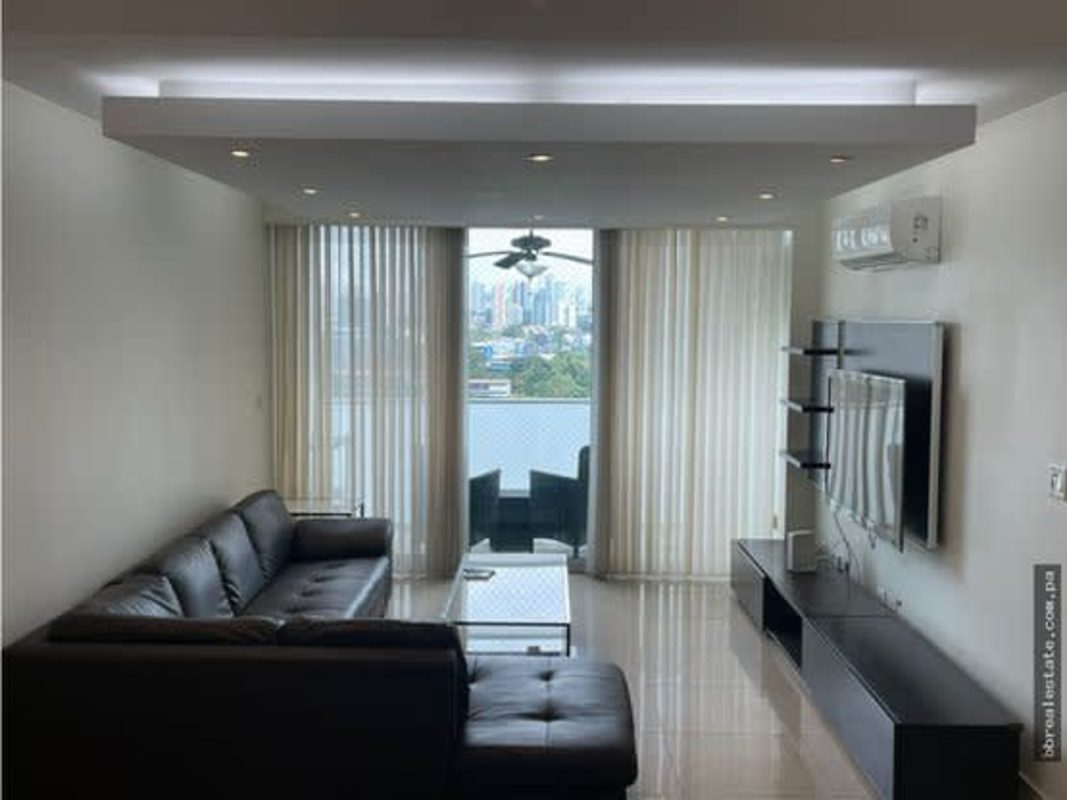 Elegant living space with leather sofa, city views, minimalist decor PH Sun & Sky Panama