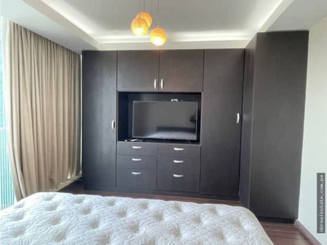 Elegant master bedroom with wood closet TV city views in PH Sun & Sky Panama