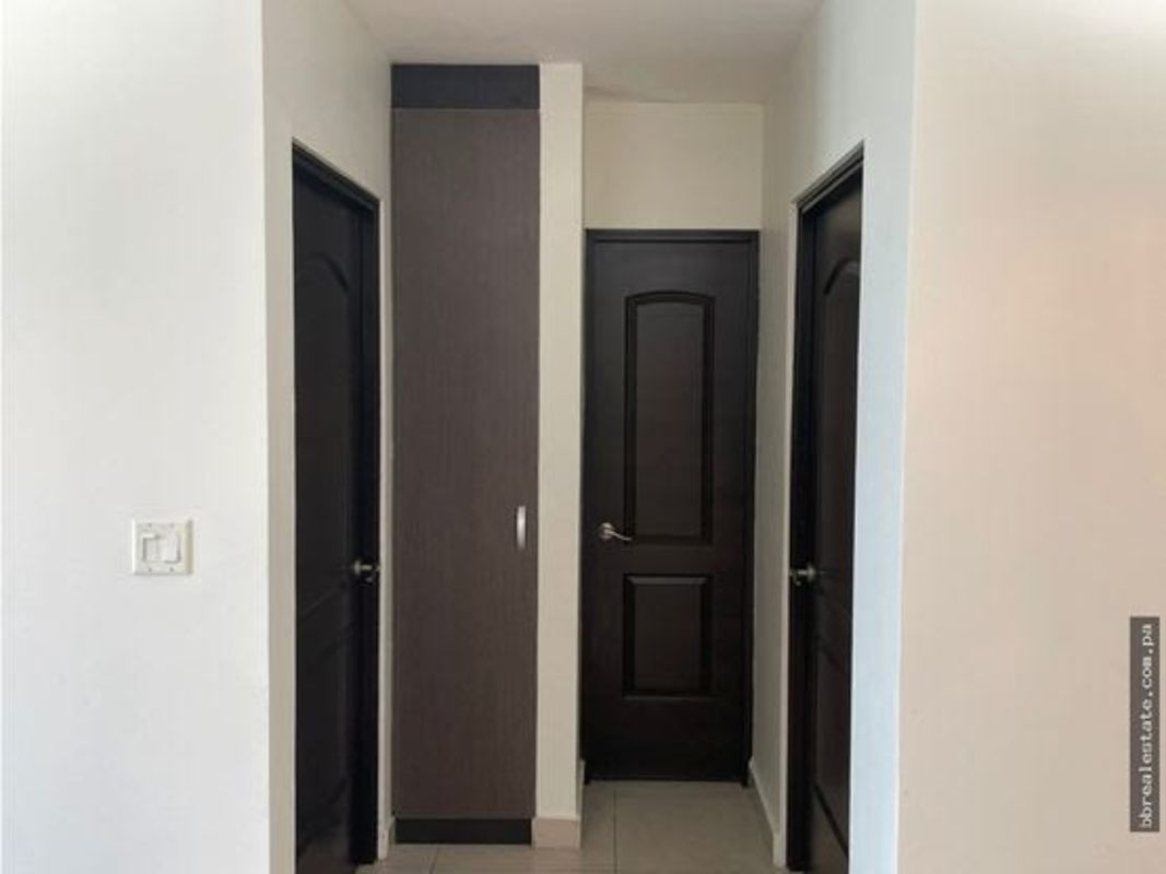 Interior hallway with built-in storage dark wood doors PH Sun & Sky Punta Pacifica Panama