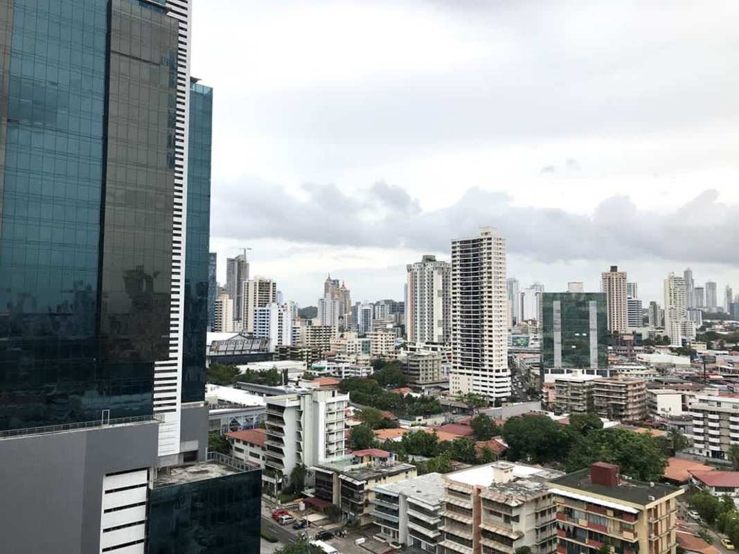 Rooftop swimming pool lounge overlooking Panama City skyline at PH Metric