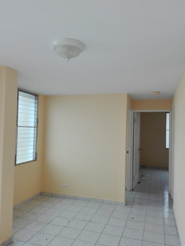 Entry hallway with cream walls, tile flooring, jalousie windows at PH Villa de las Fuentes Tumba Muerto Panama