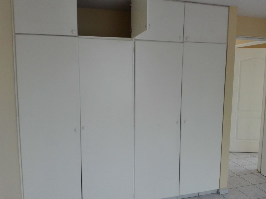 Bedroom with built-in closets, neutral tile floor, window PH Villa de las Fuentes Tumba Muerto Panama