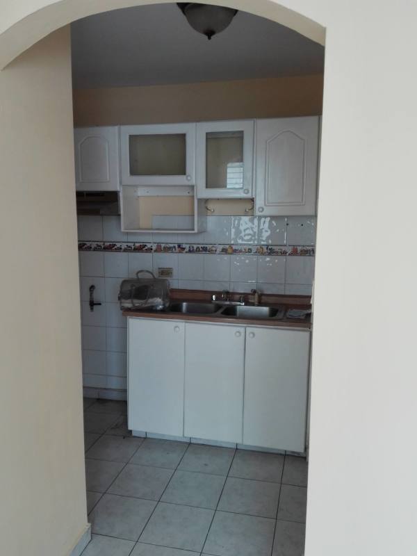 Compact kitchen with white tile backsplash and cabinets PH Villa de las Fuentes Tumba Muerto Panama