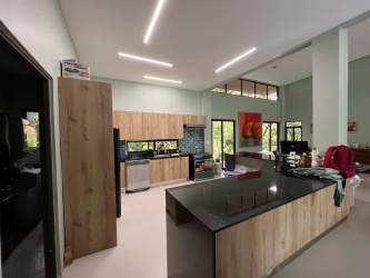 Spacious kitchen with island, wood cabinetry, mountain views Altos del María Panama