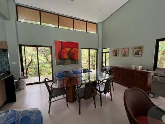 Modern dining with glass doors, views of nature Altos del María Panama