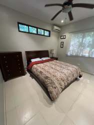 Bedroom with large window, ceiling fan, tile floor Altos del María Panama