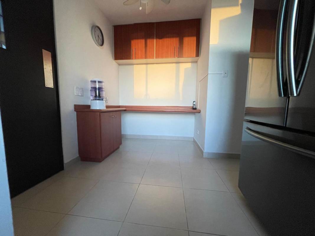 Minimalist kitchen with wood cabinetry in PH Veranda Coco del Mar Panama City