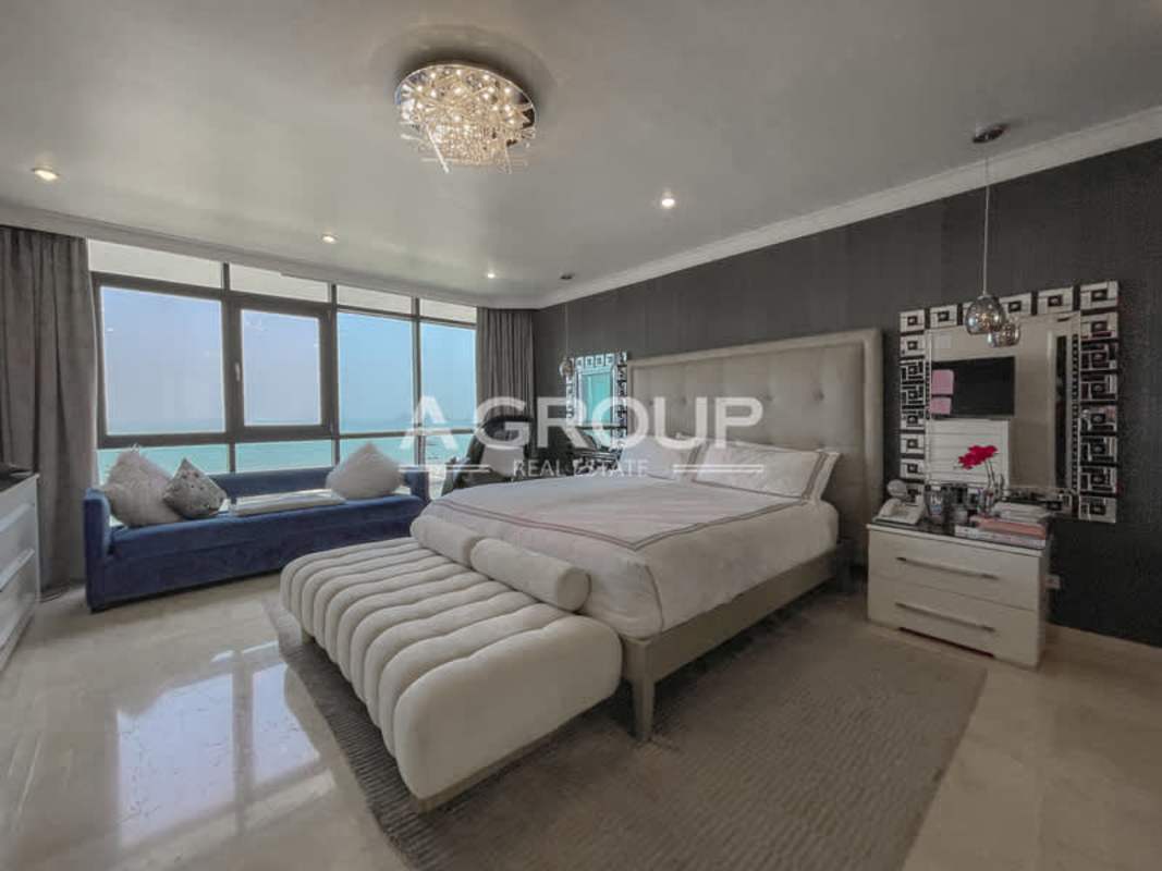 Modern open-concept living and dining area with floor-to-ceiling oceanview windows at PH Miramar Plaza Panama City