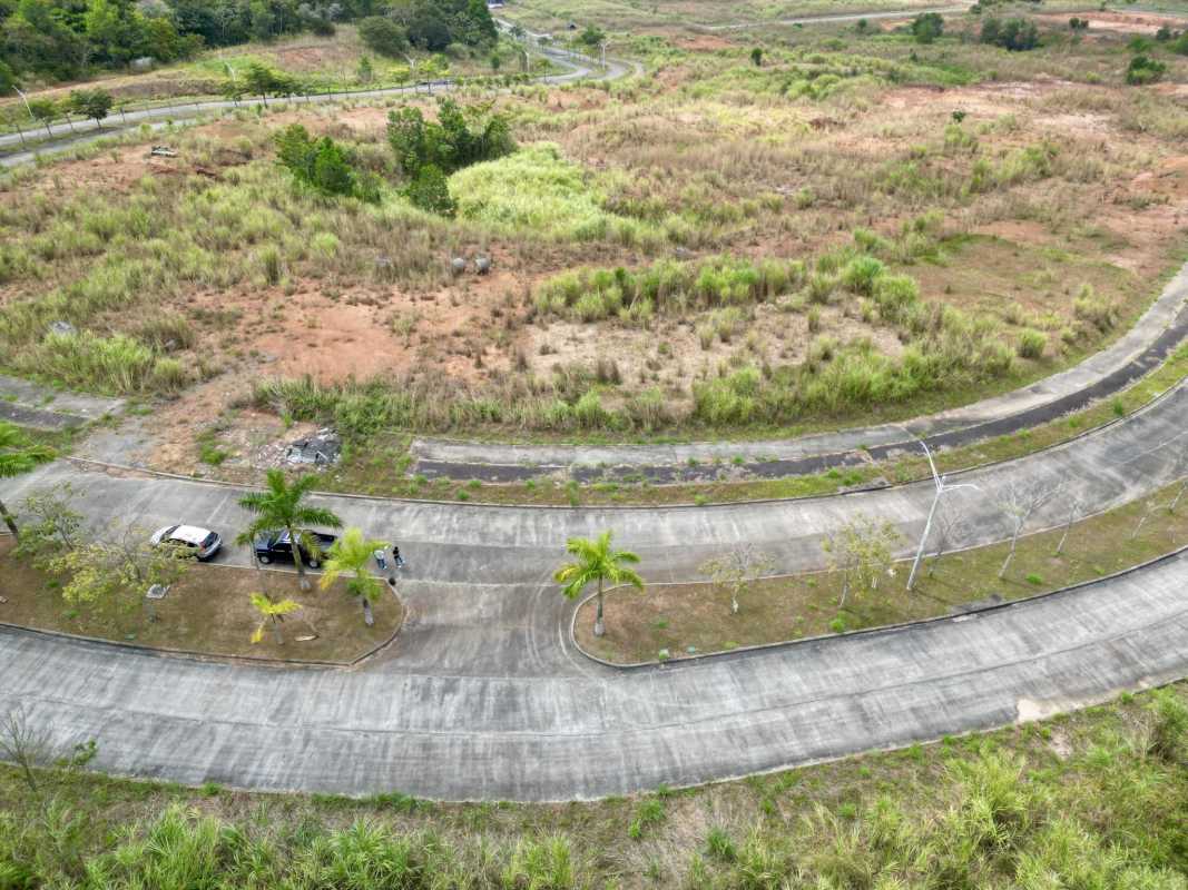 Curved paved roads near vacant land plots Green Valley Pedregal Panama