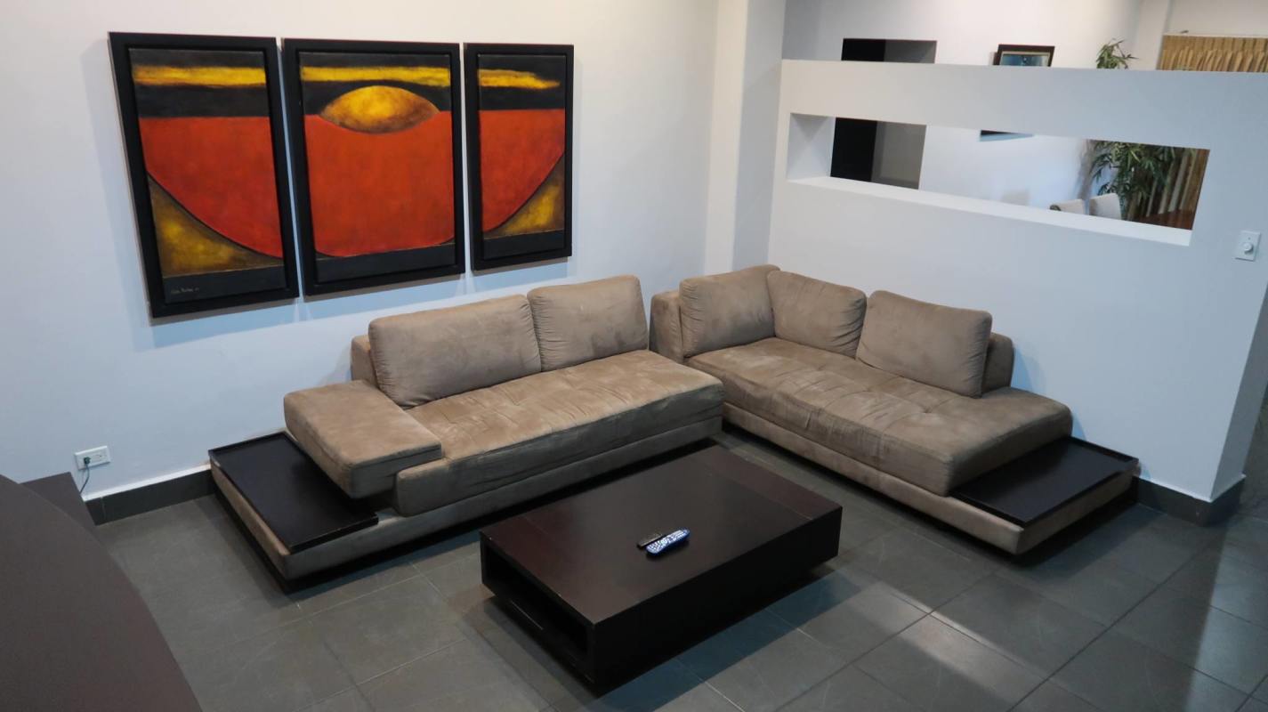 Master bedroom with beige curtains, wood headboard, large mirror and wall art Albrook Panama