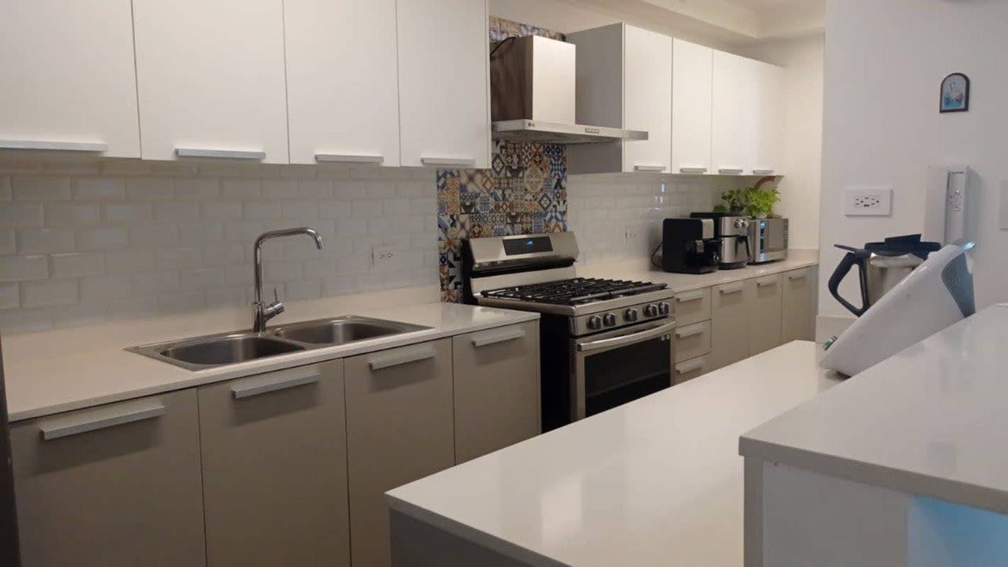 Modern gym with city skyline view, fitness machines, large windows at Altamira Residences Panama City