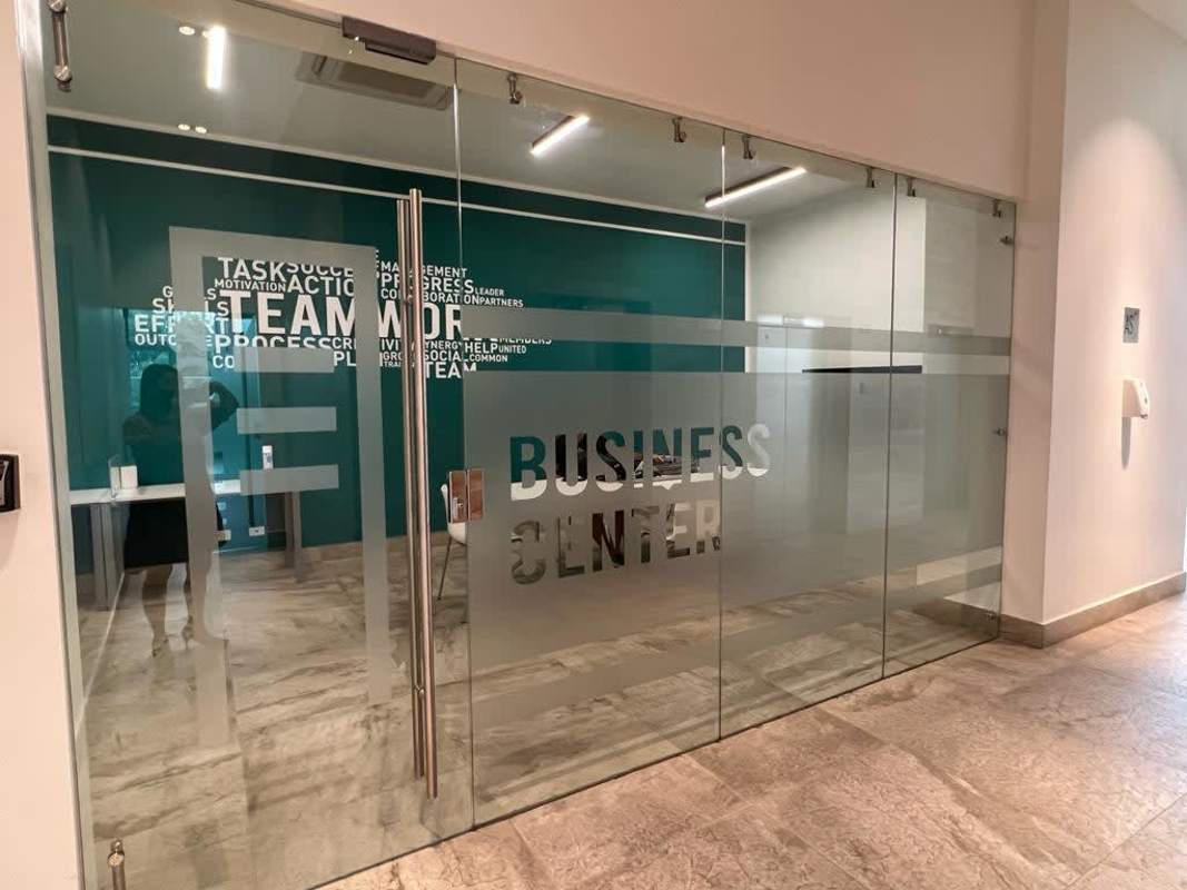 Spacious furnished living and dining area with floor-to-ceiling windows and balcony access at Altamira Residences Panama City