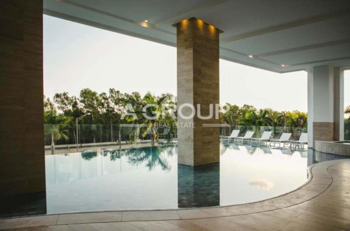 Covered infinity-edge swimming pool with sun loungers and tropical view Costa del Este Panama