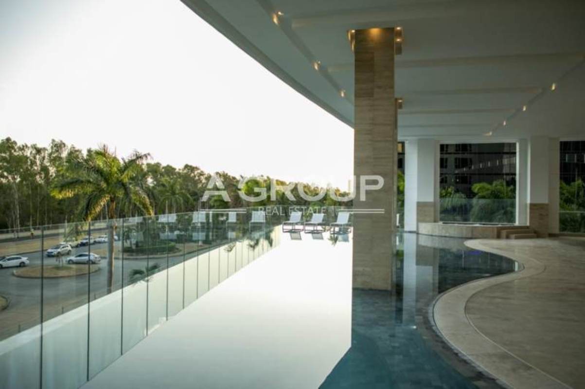 Oceanfront infinity pool with covered terrace lounge at PH Marea Costa del Este Panama