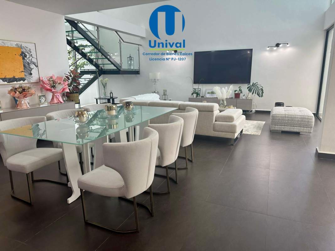 Spacious living room with double ceilings and pool view at PH Costa Esmeralda Panama