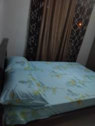 Bedroom with double bed, light blue bedding, curtains in Costa Verde Panama