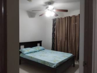 Simple bedroom with double bed, ceiling fan, curtains Isla Montelimara Panama