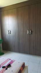 Bedroom featuring built-in wooden closet and ceiling fan in Costa Verde Panama