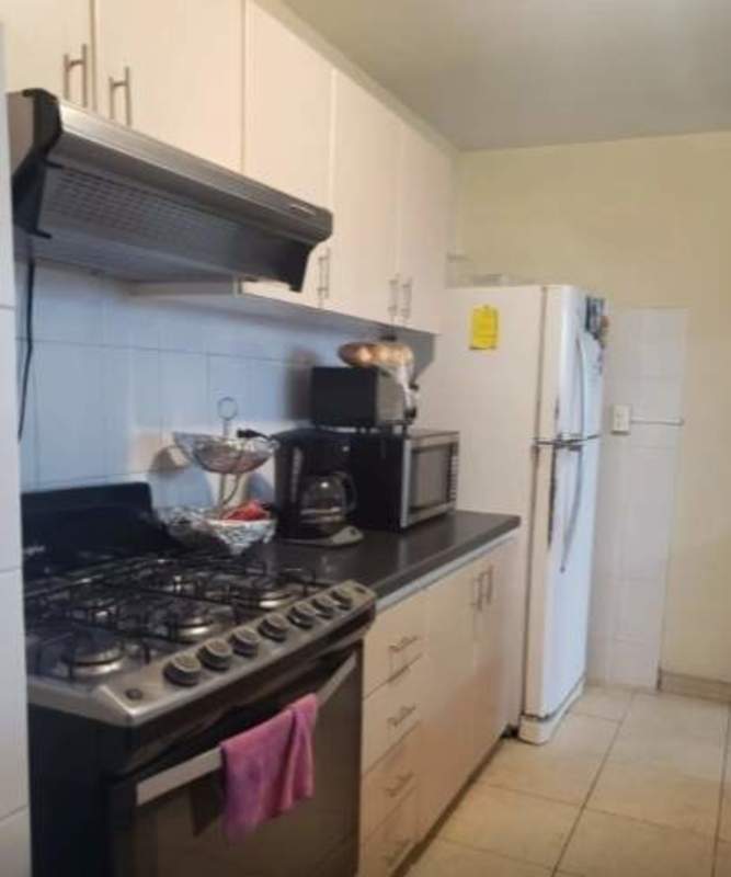 Fully equipped kitchen with white cabinets, stove, fridge in PH RIM Tower, Hato Pintado Panama