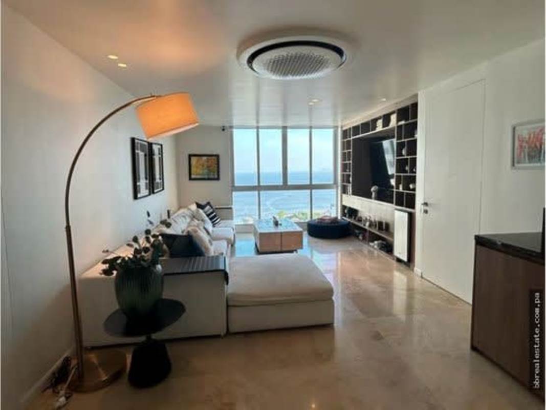 Open plan living room with floor-to-ceiling ocean view windows at PH Ocean Sky Panama
