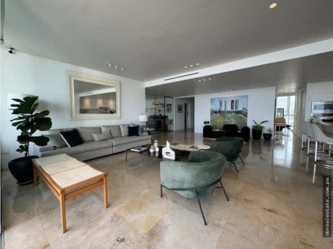 Modern furnished living space with large mirror and marble floors at PH Ocean Sky Panama