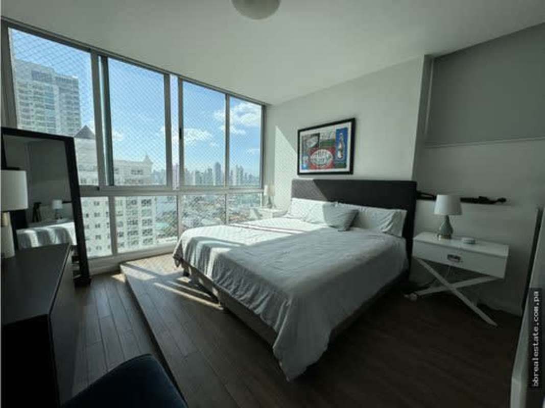Bedroom with floor-to-ceiling windows overlooking Panama City skyline in PH Ocean Sky Coco del Mar Panama