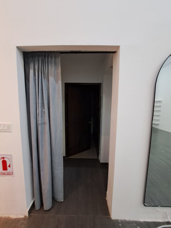 Partitioned interior with curtain and high walls in retail space Albrook Mall Panama for lease