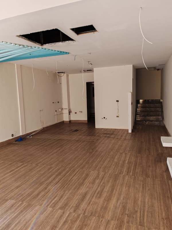 Open concept unfinished restaurant space with exposed ceiling and tile flooring Plaza 68 San Francisco