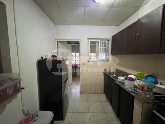 Basic kitchen interior with tiled floor, cabinets and sink at house for sale in Las Gaviotas Chitré Panama