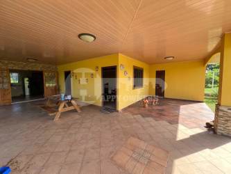 Large tiled covered patio with stone accented columns in Santa Ana countryside home Los Santos Panama