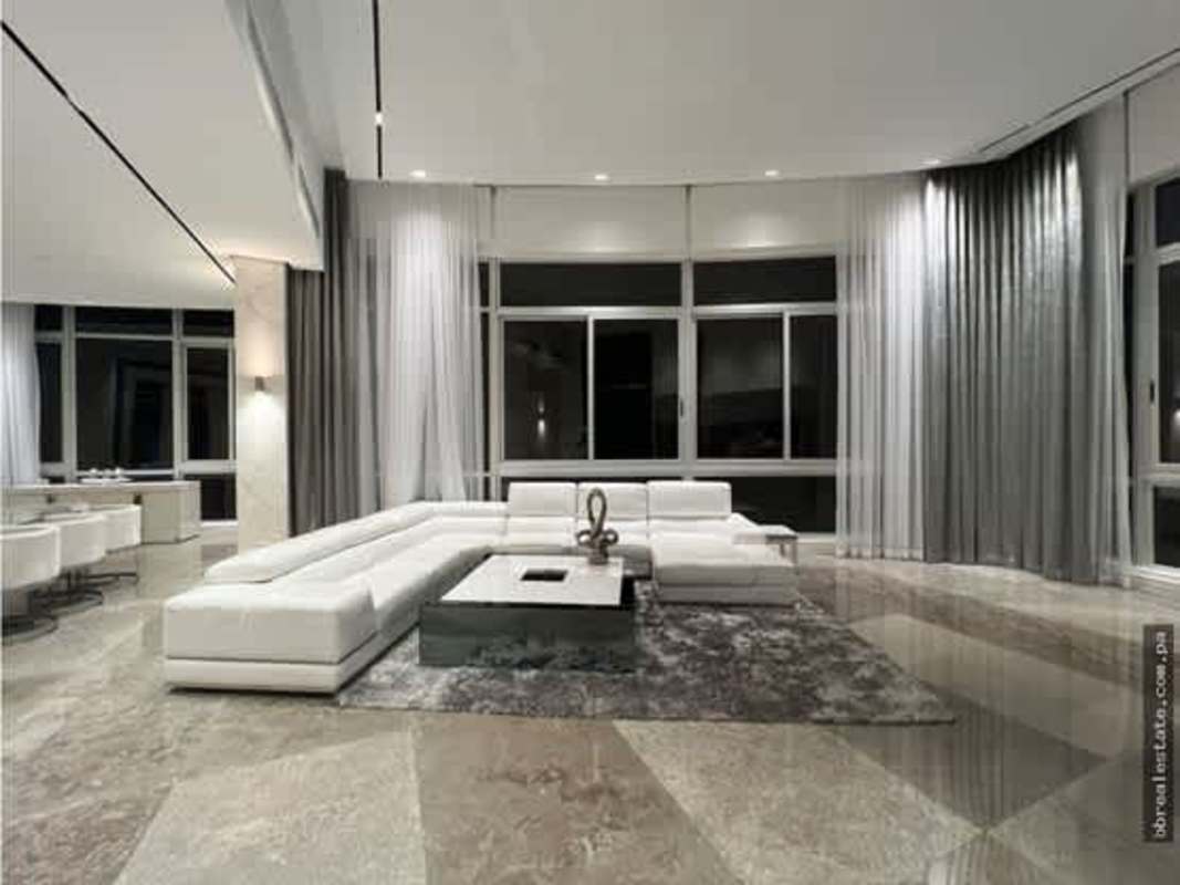 Modern dining room with floor-to-ceiling windows and Pacific ocean view PH Blue Bahia Panama