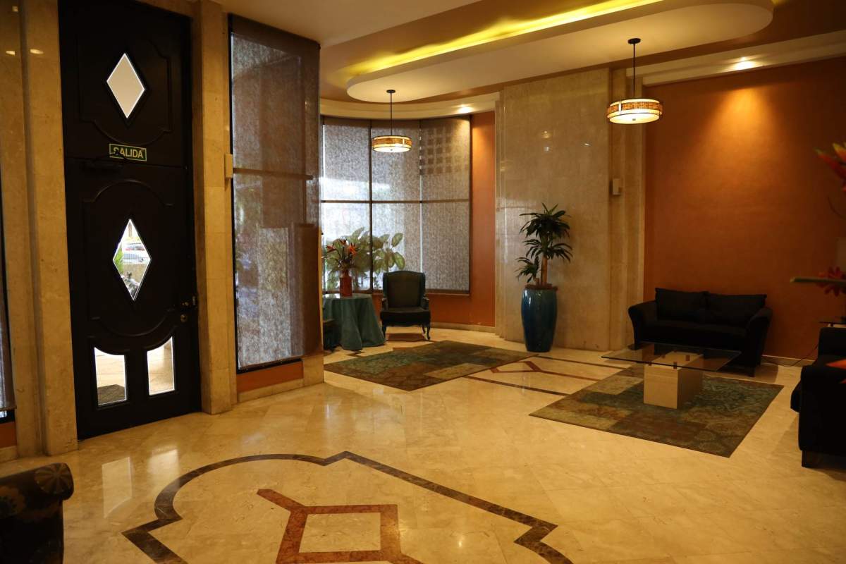 Living dining area with sliding glass doors to balcony overlooking city in PH Brisas Obarrio Panama