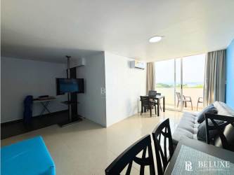 Bright living and dining space with access to balcony facing beach and lagoon in Playa Blanca