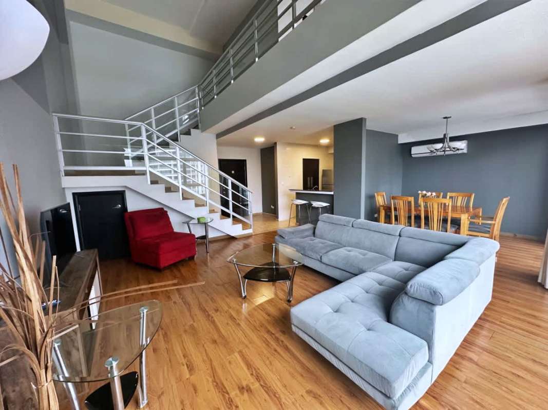 Spacious balcony with ocean view and glass railing, fully furnished loft apartment in Bayfront Panama