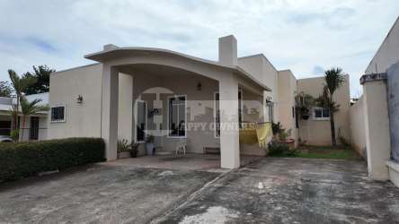 Covered porch entrance with garden view Marbella Chitré Panama house for sale