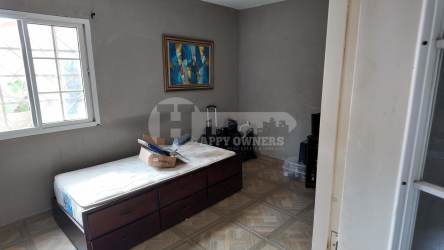Bedroom with window, neutral colors, and tiled floor Chitré Panama house