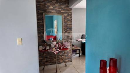 Entryway interior with decorative stone wall, mirror, console Marbella Chitré Panama