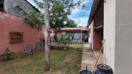Outdoor covered patio kitchen with wood cabinets and dining Marbella Chitré Panama