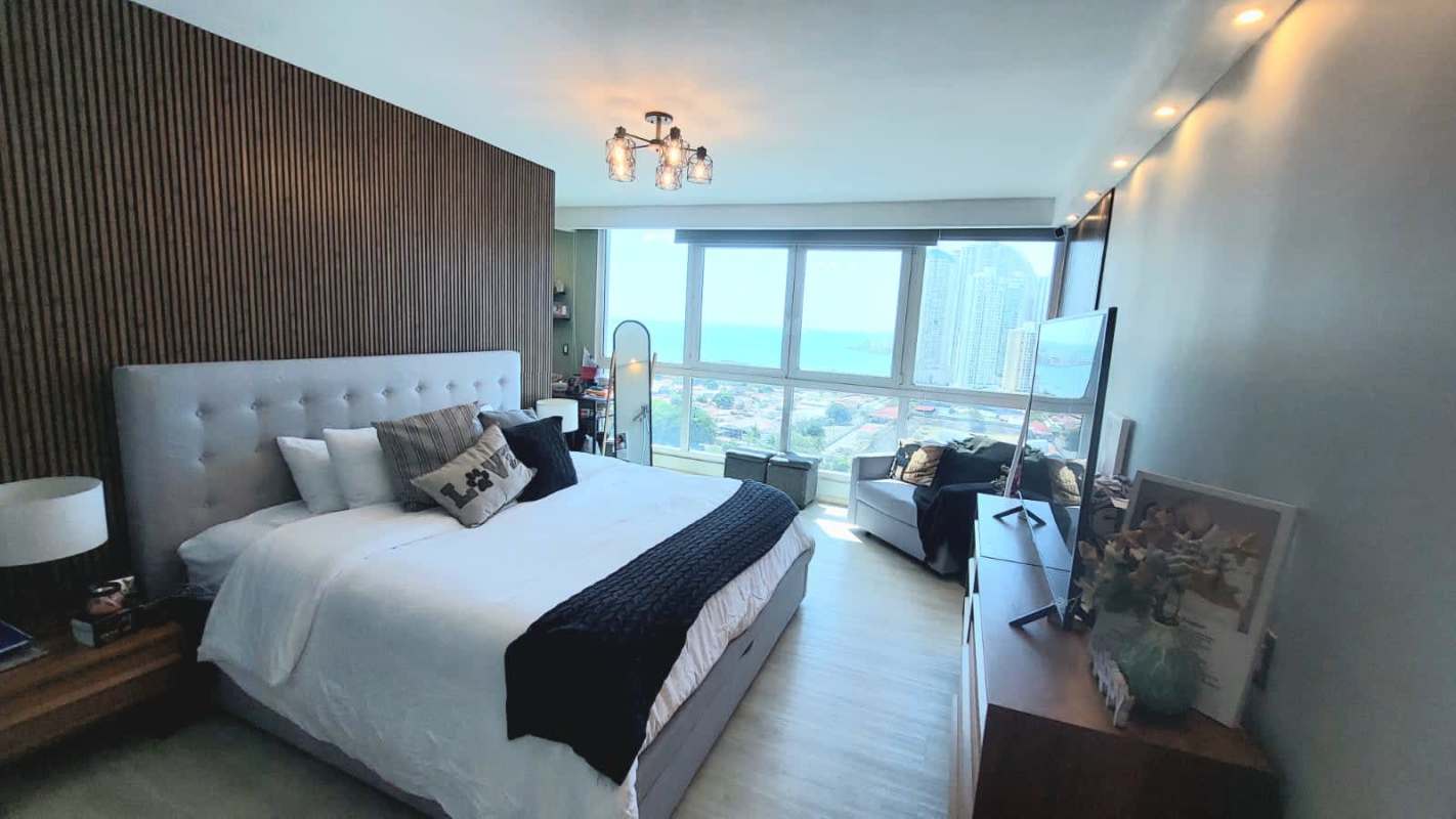 Bright bedroom with wood floors, large windows overlooking ocean and Panama skyline PH Marina Plaza San Francisco